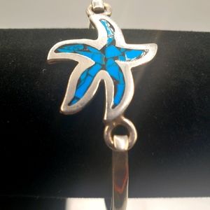 Sterling silver w turquoise   Starfish bracelet measures 8 inches circumference.